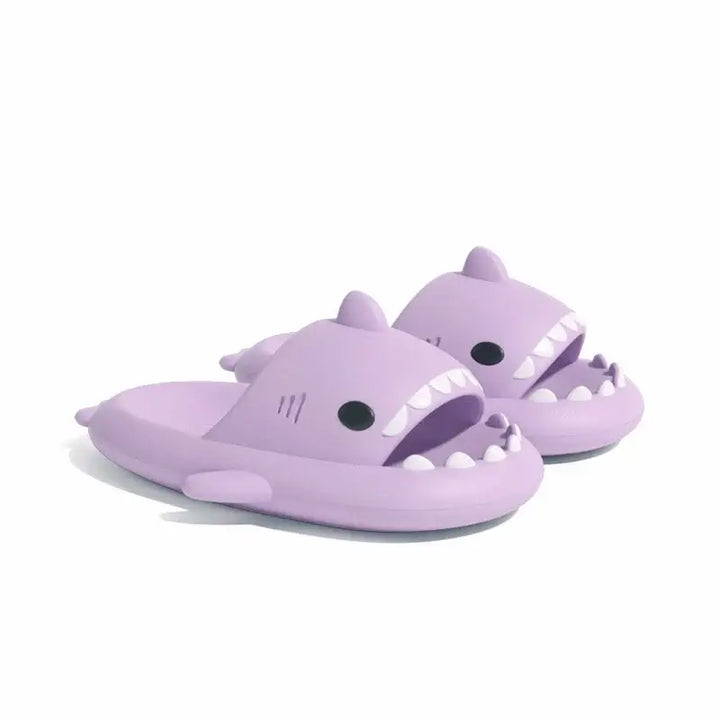 Purple shark design slippers, combining comfort and style for indoor use.
