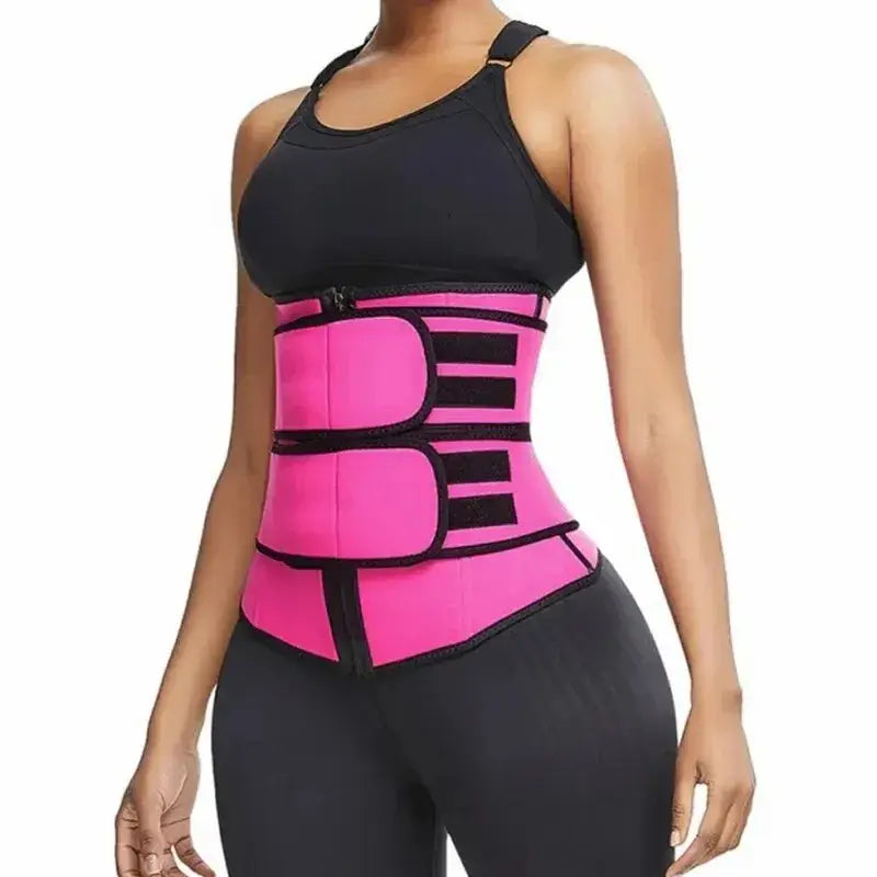 Woman wearing pink neoprene sweat belt shapewear for waist retraction and belly support, enhancing workout efficiency.