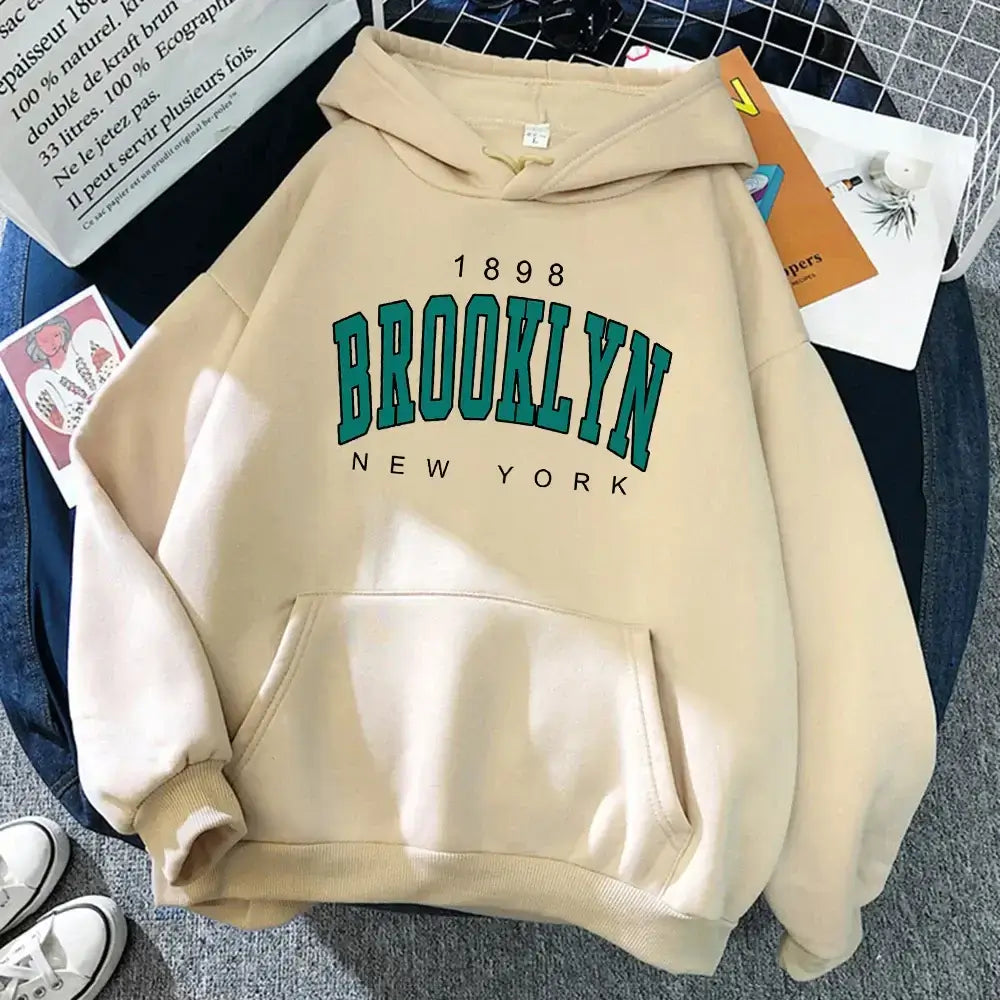 Beige Brooklyn Hoodie featuring bold Brooklyn print, unisex fleece pullover for NYC streetwear style