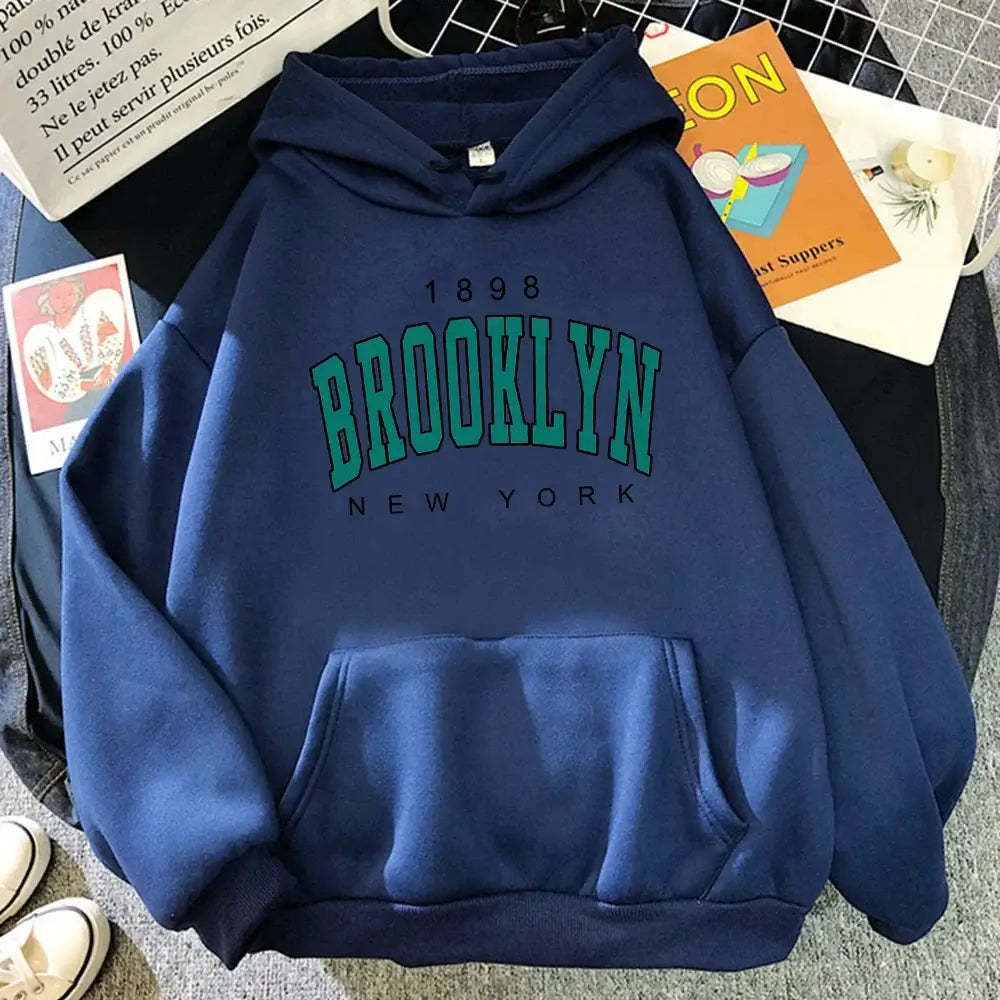 Showcasing the front view of the Brooklyn Hoodie, this piece embodies the essence of New York fashion with its bold print and relaxed fit.