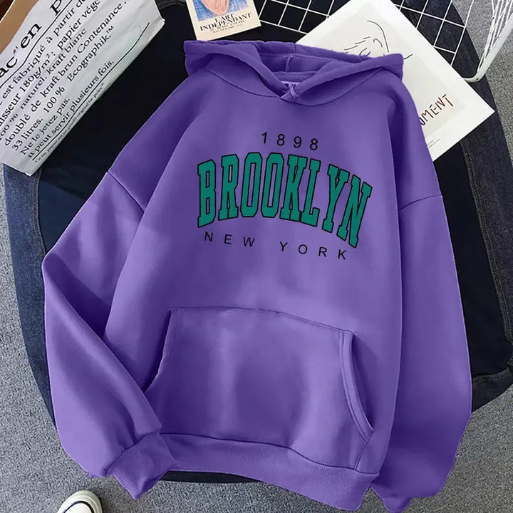 The cozy back view of the Brooklyn Hoodie highlights its soft fabric, perfect for keeping you warm on chilly days while maintaining style.