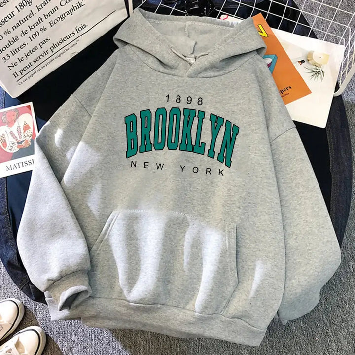 Stylish grey Brooklyn hoodie featuring iconic print, unisex design perfect for casual outings