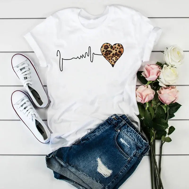 Trendy white 90s Graphic Women's Tee with a leopard heartbeat print. Ideal for casual wear and showcasing 90s-inspired style.